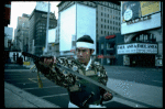 A castmember from the Broadway production of the musical "Pacific Overtures" posing in the middle of Times Square to advertise the show. (New York)