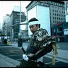 A castmember from the Broadway production of the musical "Pacific Overtures" posing in the middle of Times Square to advertise the show. (New York)