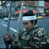 A castmember from the Broadway production of the musical "Pacific Overtures" posing in the middle of Times Square to advertise the show. (New York)