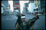 A castmember from the Broadway production of the musical "Pacific Overtures" posing in the middle of Times Square to advertise the show. (New York)