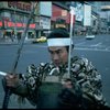 A castmember from the Broadway production of the musical "Pacific Overtures" posing in the middle of Times Square to advertise the show. (New York)