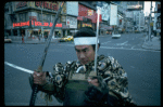 A castmember from the Broadway production of the musical "Pacific Overtures" posing in the middle of Times Square to advertise the show. (New York)