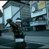 A castmember from the Broadway production of the musical "Pacific Overtures" posing in the middle of Times Square to advertise the show. (New York)