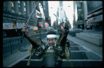 A castmember from the Broadway production of the musical "Pacific Overtures" posing in the middle of Times Square to advertise the show. (New York)