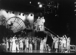 A scene from the Broadway show "City of Angels" featuring actors (L-R) James Naughton, Dee Hoty and Gregg Edelman (in the crane).