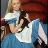 Actress Kate Burton w. cat in a publicity shot fr. the Broadway revival of "Alice in Wonderland."