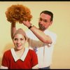 Actress Danielle Findley being fitted with red "Annie" wig in a publicity shot for the Broadway musical "Annie 2: Miss Hannigan's Revenge." (New York)