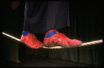 The feet of actor Avner Eisenberg walking a tightrope in a scene fr. the Off-Broadway one man show "Avner the Eccentric." (New York)