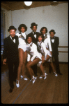Dancers Charles "Cookie" Cook (Back L), Charles "Honi" Coles (Back C) & Leslie "Bubba" Gaines (Back R) w. ensemble (incl. dancer Mercedes Ellington, Front R) in a publicity shot fr. the Broadway revue "Black Broadway." (New York)