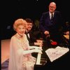Entertainer the "Incomparable" Hildegarde at the piano & announcer Don Wilson (R) in a scene fr. the concert "Big Broadcast of 1944." (Westbury)