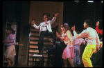Actor Jim Walton (C) w. cast in a scene fr. the Broadway musical "Merrily We Roll Along." (New York)