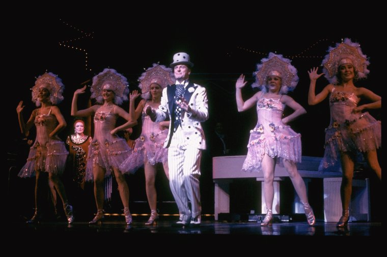 Actor Peter Allen (C) in a scene fr. the Broadway musical 