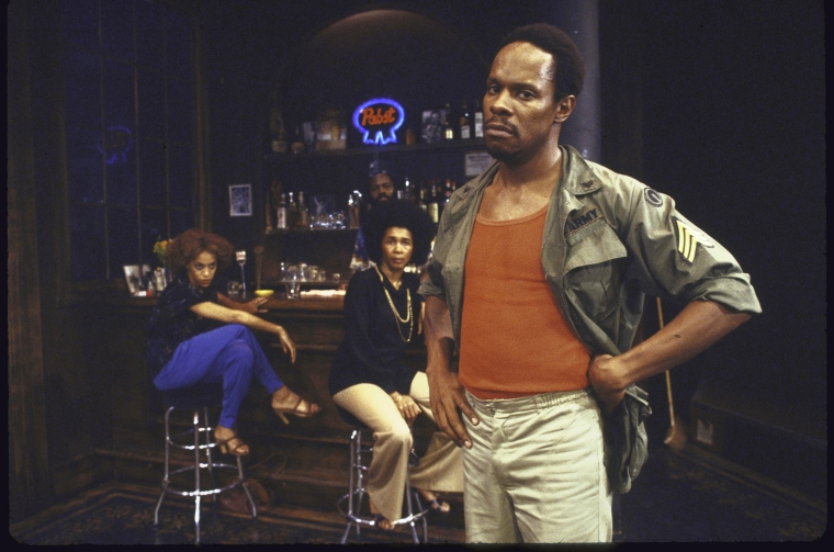 Actor Avery Brooks with cast members in a scene from the New York Shakespeare Festival production of the play &quot;spell #7.&quot; (New York) - NYPL Digital Collections