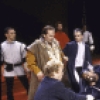 Actor Denzel Washington (C, on table) with cast members in a scene from the New York Shakespeare Festival production of the play "Richard III" at the Delacorte Theatre in Central Park (New York)