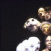Actress Robbie McCauley with masked figures in a scene from the Interart Theatre's production of the performance piece "Solo Voyages" (New York)