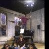 Actress Mary Lou Rosato (standing on piano) with actors (L-R) John Procaccino, Christopher Colet and Evan Miranda in a scene from the New York Shakespeare Festival's production of the play "Coming Of Age In Soho" (New York)