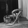 New York City Ballet dancer in the wings tying shoe before performance of "The Cage", choreography by Jerome ..Robbins (New York)
