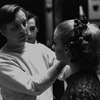New York City Ballet production of "Illuminations" John Taras backstage adjusts Sara Leland's makeup, choreography by Frederick Ashton (New York)