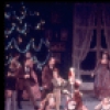 Christmas party scene with boys and their drums interrupting girls with dolls, in a New York City Ballet production of "The Nutcracker."