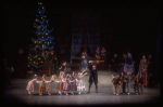 Act I party scene with Andre Kramarevsky as Drosselmeyer giving children stick horse, in a New York City Ballet production of "The Nutcracker" (New York)