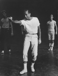 Choreographer Jerome Robbins, in white t-shirt, pants, socks and tennis shoes, directing a rehearsal of "West Side Story".