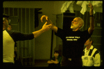 Choreographer Jerome Robbins, (R) wearing t-shirt reading "It's going well thank you," instructing dancer during rehearsal for show "Jerome Robbins' Broadway.