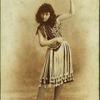 Dancer in striped stockings and fringed skirt