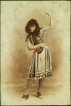 Dancer in striped stockings and fringed skirt