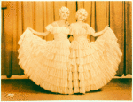 Dancers in long ruffled skirts