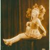 Female dancer sitting on a pillar