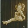Female dancer sitting on a pillar