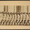 Chorus dancers wearing large hats